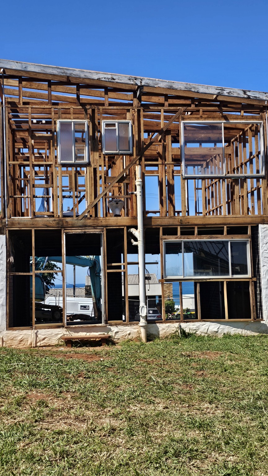 Two-storey building after an internal and external removal, with timber framing exposed and existing windows retained.